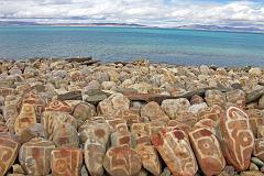 Tibet Kailash 07 Manasarovar 02 Seralung Mani Rocks A row of mani rocks shine in one of the brief sunny breaks next to Seralung Gompa on the shores of Lake Manasarovar.